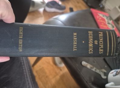 An original hardcover printing of Alfred Marshalls Principles of Economics eighth Edition published by Macmillan