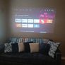 philips neopix ultra 2tv+ home projector and height adjustable stand, built in speakers and android TV with play store stand comes with power point bracket on it as seen in pictures also remote and phone holder Image 6