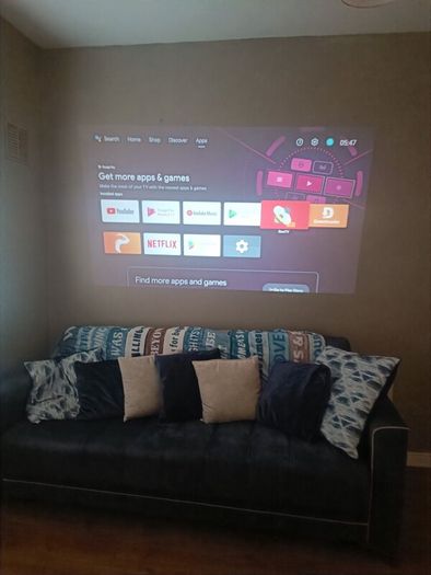 philips neopix ultra 2tv+ home projector and height adjustable stand, built in speakers and android TV with play store stand comes with power point bracket on it as seen in pictures also remote and phone holder