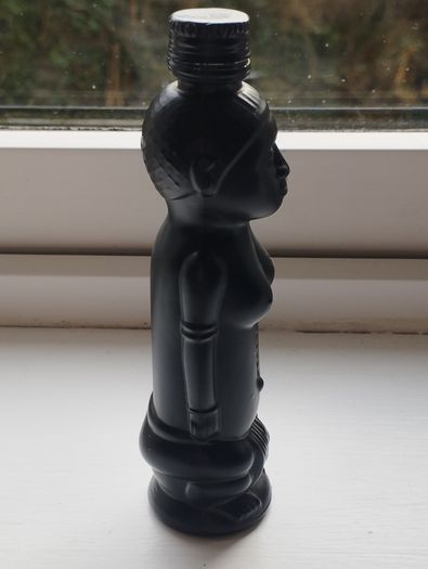 Vintage miniature "VUDU" bottle made of opaque black glass.