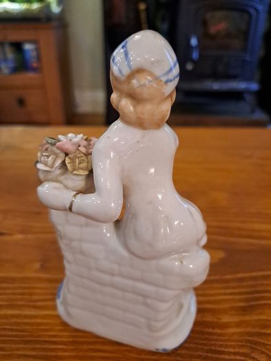 Vintage porcelain woman figurine detailed flowers