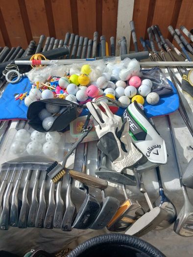 A selection of Golf clubs. Bags and golf balls.