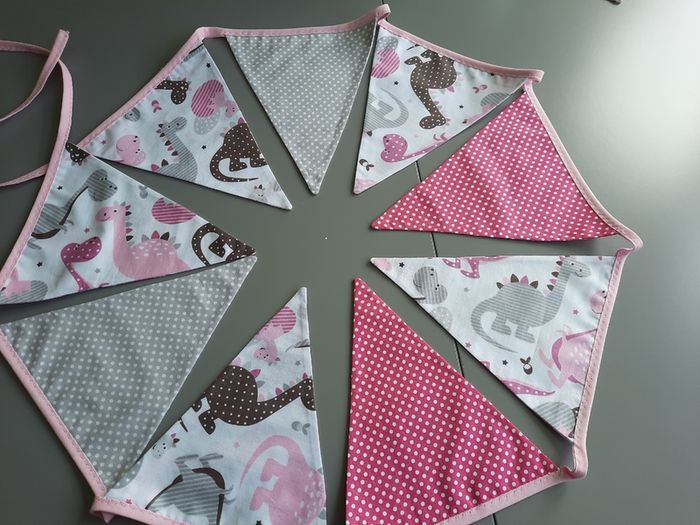Dinosaur buntings . Blue and pink