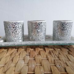 This mosaic glass set features three silver-crushed glass votive holders on a matching mirrored tray