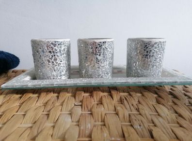 This mosaic glass set features three silver-crushed glass votive holders on a matching mirrored tray