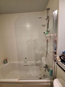 Glass shower screen for a bath