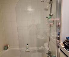 Glass shower screen for a bath