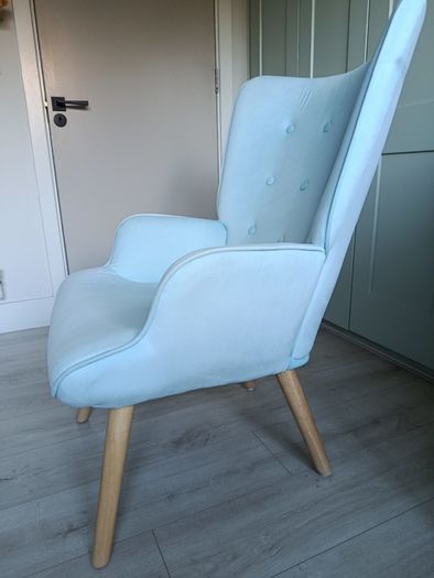 Light blue button-back armchair