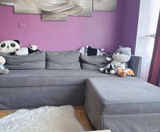 Grey fabric sofa with matching footstool