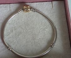 Authentic Pandora sterling silver bracelet with a 14k solid yellow gold clasp (marked G585 ALE).Size 18.5cm for the right size please check the last photos, in  very good condition
