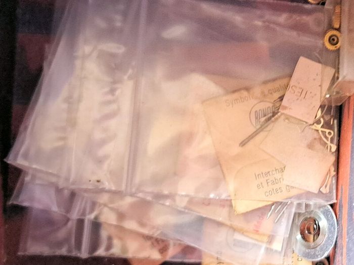 Boxes of miscellaneous watch parts