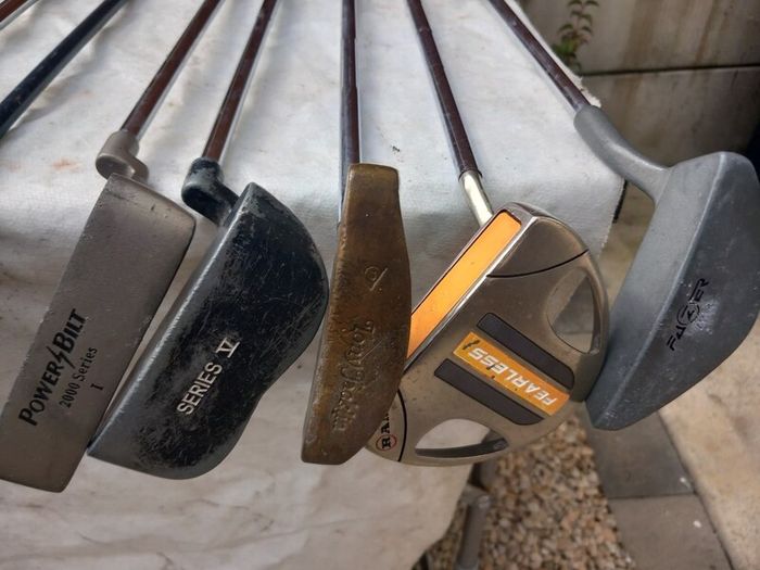 A selection of Golf clubs. Bags and golf balls.