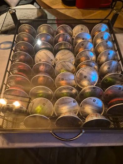nespresso vertuo plus machine and coffee pods with holding tray