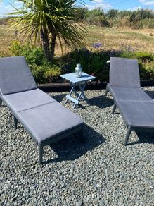 2 black pvc Sun loungers ahd grey cushions