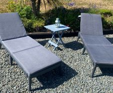 2 black pvc Sun loungers ahd grey cushions