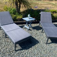 2 black pvc Sun loungers ahd grey cushions