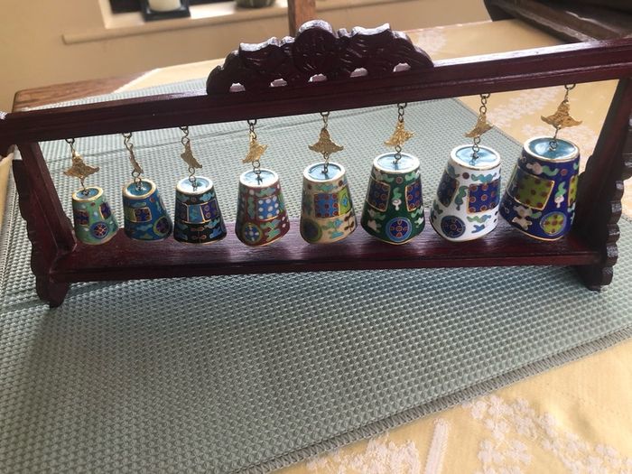 Enamel cloisonne graduated bells on wooden stand