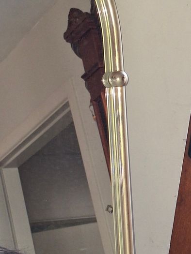 Beautiful Late 20th century Arched Brass Colored Metal Wall Mirror, the arched plate within tubular uprights with spherical finials. Collection is Preferred