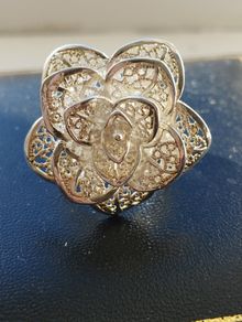 A 925 sterling silver cocktail ring in the shape of a flower.