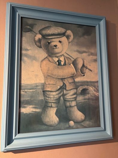 Teddy playing golf print in a blue wooden frame