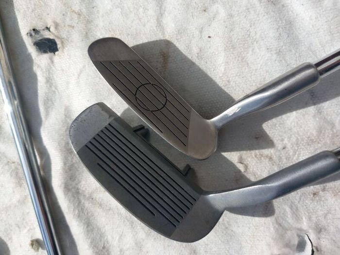 A selection of Golf clubs. Bags and golf balls.