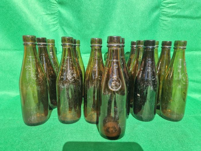 24 Antique 1/2 pint bottles in crate