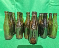 24 Antique 1/2 pint bottles in crate