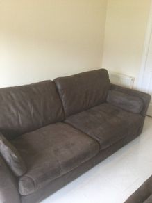 Two distressed leather sofas and a fabric sofa bed