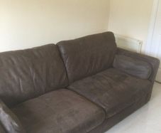 Two distressed leather sofas and a fabric sofa bed