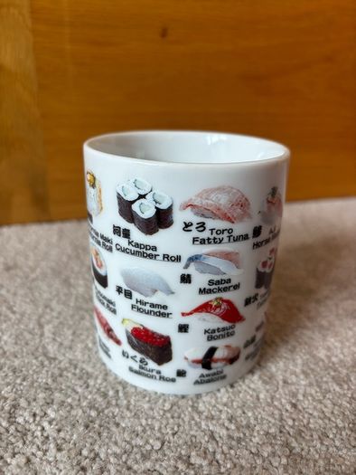 A Mug Featuring Different Types of Sushi