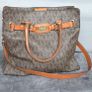 Michael Kors brown signature large handbag with shoulder strap. Spacious interior with multiple pockets. In perfect condition apart from one small tear, as shown in the photo. Image 2