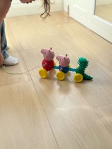 TOMY Toomies Pull Along Peppa - Wibble Wobble Action Peppa Pig, George & Dinosaur Toy - Wheeled Walking & Crawling Toddler Toys