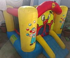 Happy Hop clown-themed bouncy castle with blower