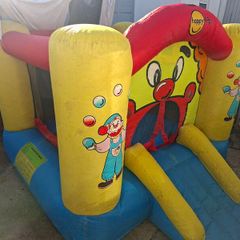 Happy Hop clown-themed bouncy castle with blower