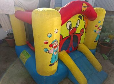 Happy Hop clown-themed bouncy castle with blower