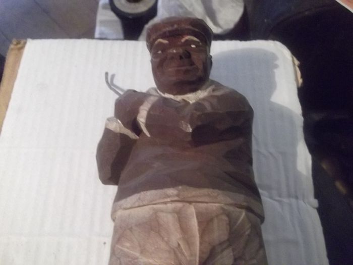 a antique carved wood golfer