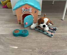 Cute stuffed dog and dog house