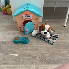 Cute stuffed dog and dog house