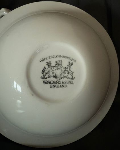 An antique Weatherby Design ironstone pitcher and bowl set featuring a wheat pattern.