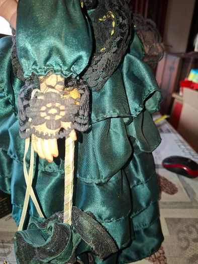 Vintage Large Victorian-style collectible Porcelain Doll featuring curly reddish-brown hair and a multi-layered emerald green satin and lace dress