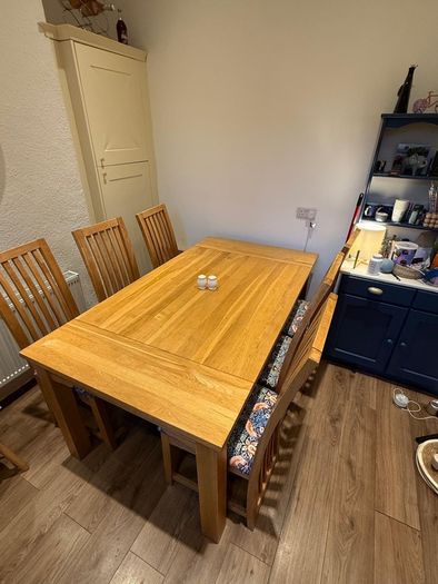 Solid oak dining table & 6 reupholstered dining chairs