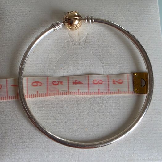 Pandora Moments two-tone bangle ir sterling silver with a 14k yellow gold ball clasp. (Size approx 19cm) for the right size please check all the photos (the bracelet is in very good condition)