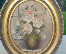 Oval oil painting depicting a still life with flowers,