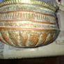 Antique Copper Cauldron features a Rustic Patina, a Swing Handle, and Distinctive Ribbed Detailing around the Rim. It resembles vintage metal pots often used for hearth decoration or as Planters. The piece shows significant oxidation and aging, characteri Image 4