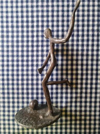 Vintage brass figurine of a football player