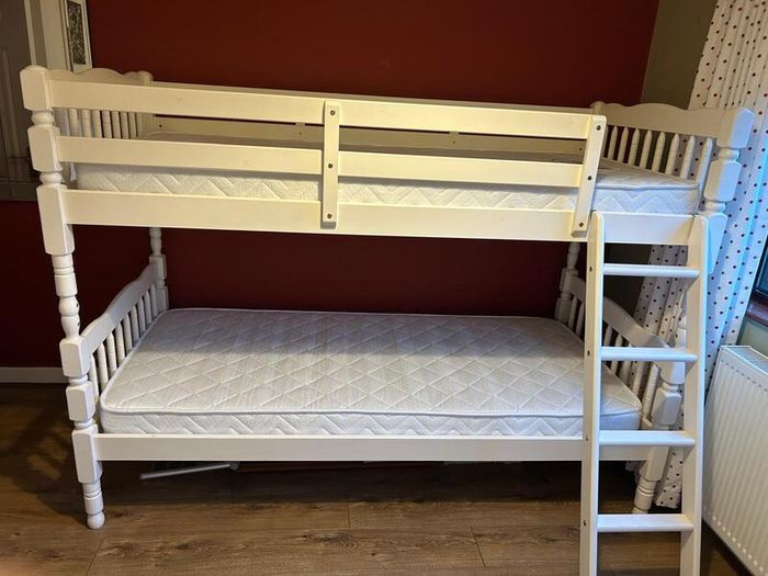 White wooden bunk beds with mattresses