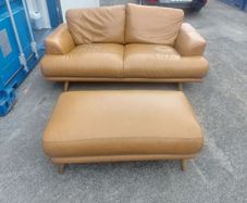 Brown leather couch and matching foot stool