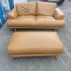 Brown leather couch and matching foot stool
