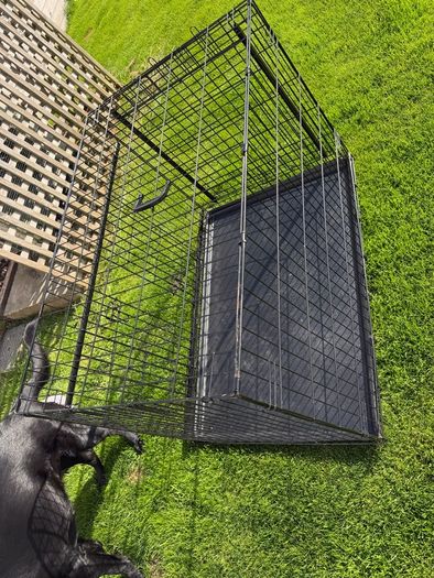 XL dog crate opens up by sliding doors at front and side. Read caption
