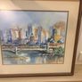 The framed watercolor painting appears to depict an impressionistic cityscape featuring a historic stone bridge over a river, similar in style and subject to watercolor prints of Princes Bridge in Melbourne or the Melbourne Skyline with Yarra River Image 4
